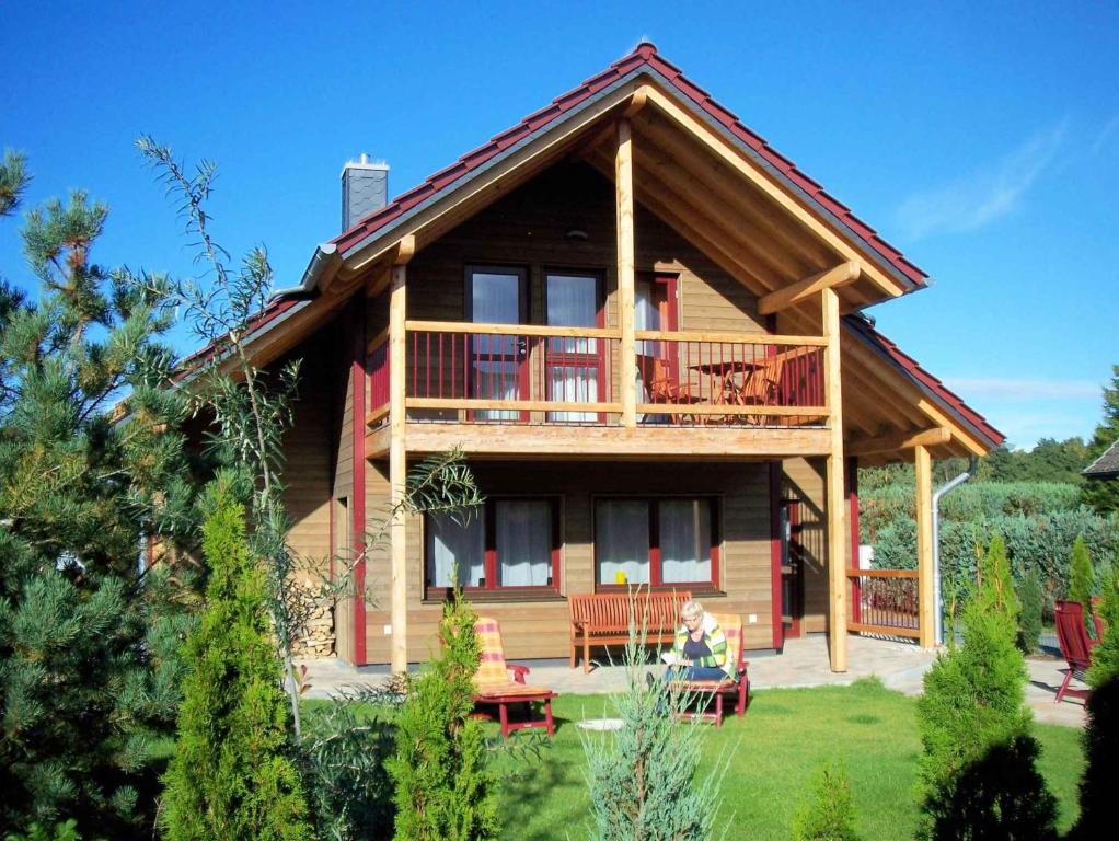 a log house with a balcony and a deck at Holiday home in Zempin (Seebad) 3239 in Zempin