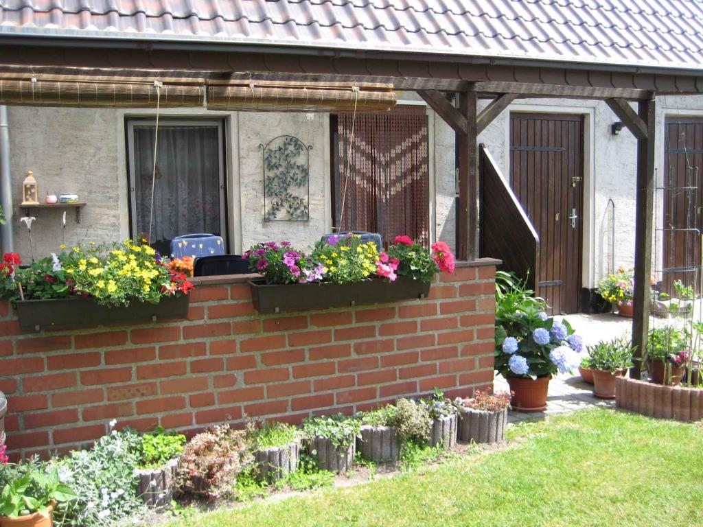 a brick wall with flower boxes on it at Holiday home Groß Kordshagen/Ostsee 2741 in Arbshagen