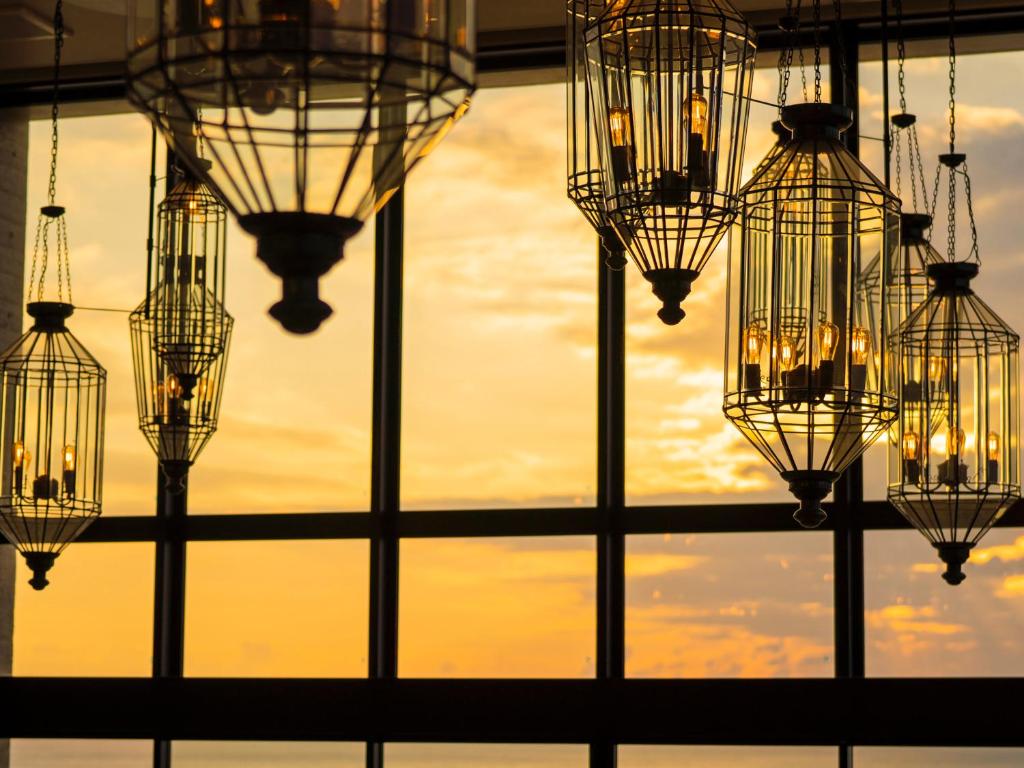 a group of chandeliers hanging from a ceiling at MB GALLERY CHATAN by THE TERRACE HOTELS in Chatan