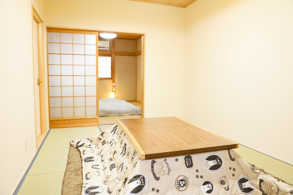 KoizumiにあるHAT Koizumi, near from JR Koizumi station 大和小泉駅徒歩2分の貸切一軒家のテーブルとベッドが備わる部屋