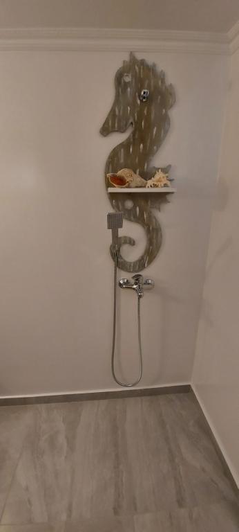 a plate of food on a shelf on a wall at Symi . VILLA CALME (Sur la Mer). in Symi