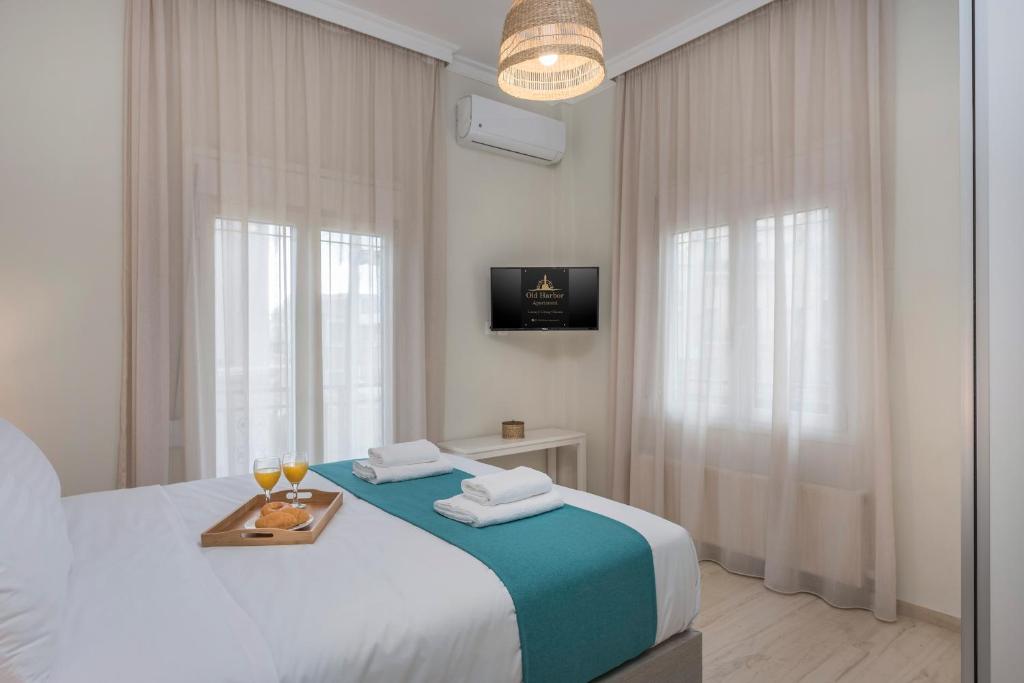 A bed or beds in a room at Old Harbor Apartment Luxury Living Chania