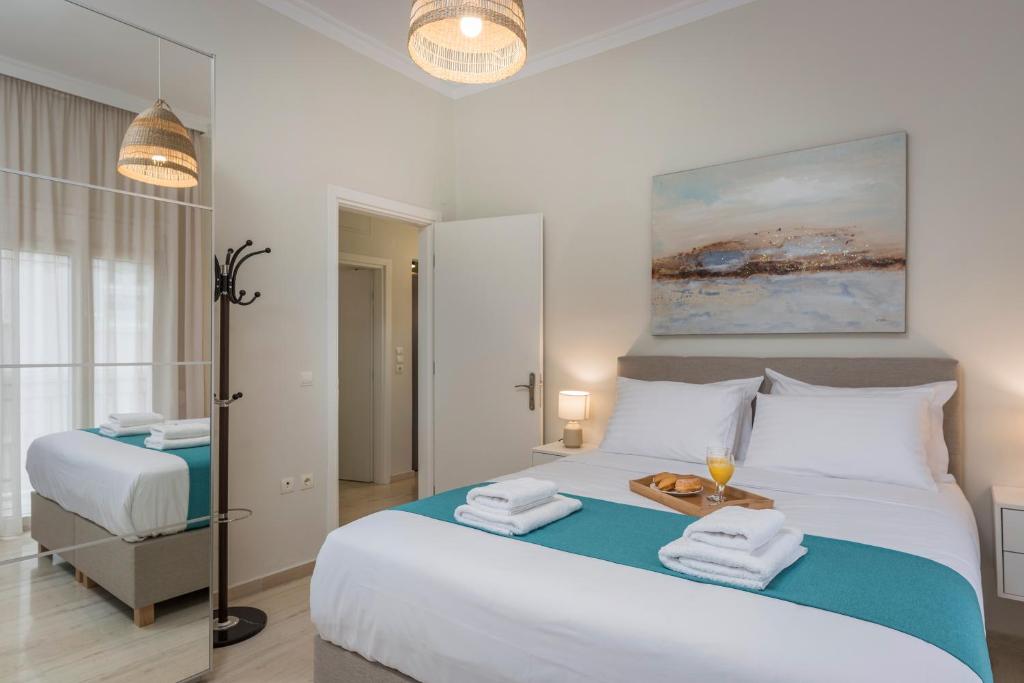 A bed or beds in a room at Old Harbor Apartment Luxury Living Chania