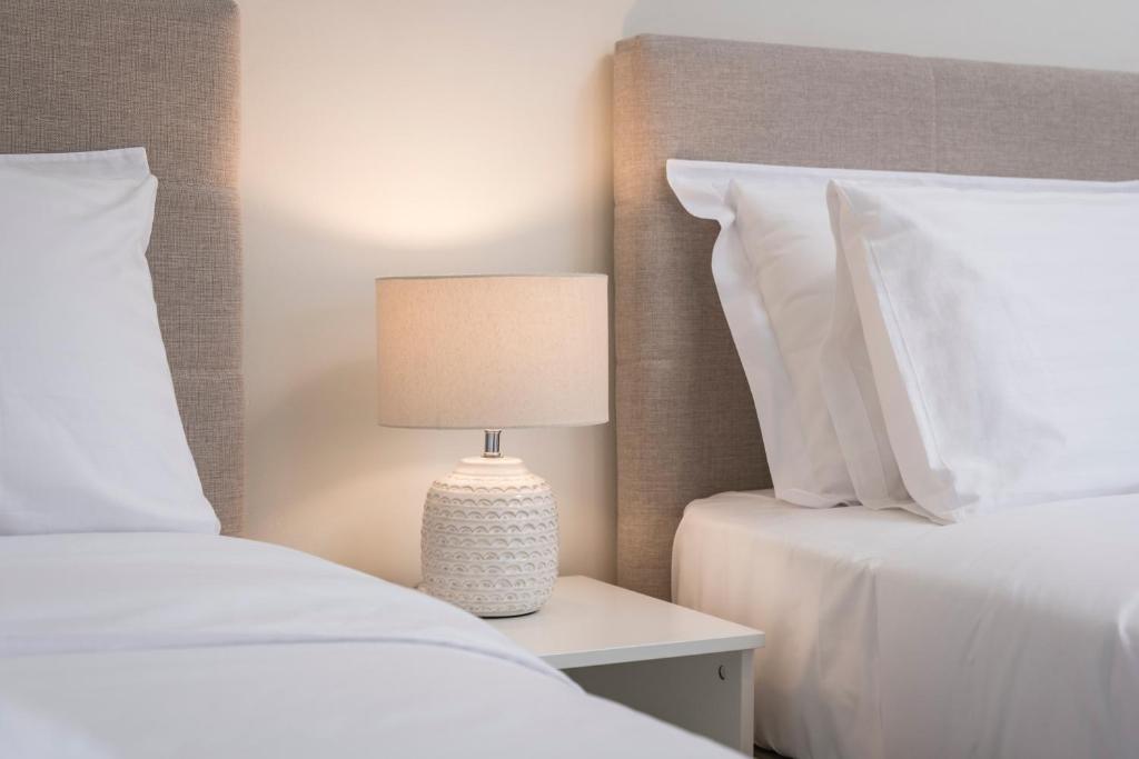 A bed or beds in a room at Old Harbor Apartment Luxury Living Chania