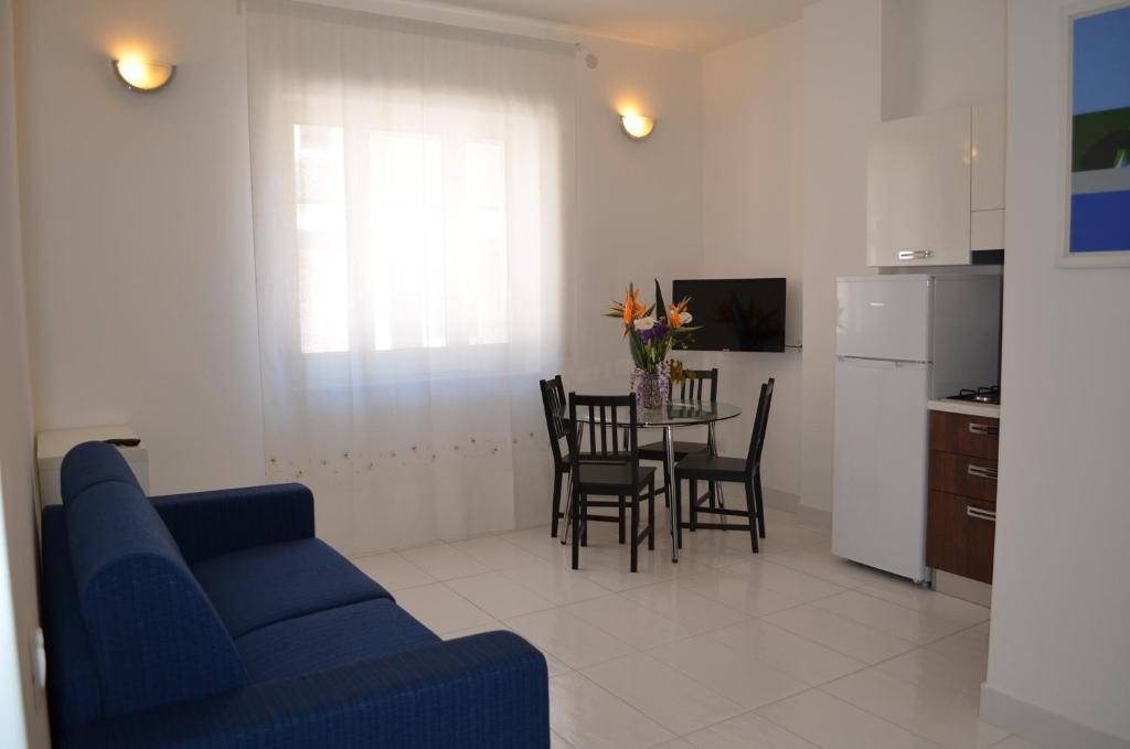 a living room with a blue couch and a table at Case Maiori in Maiori