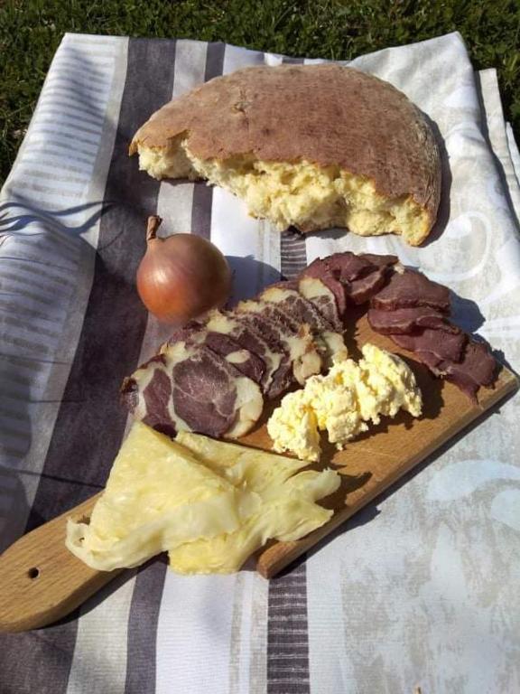 a plate of food with a sandwich and cheese at Dulović - KATUN POTOCI in Kolašin