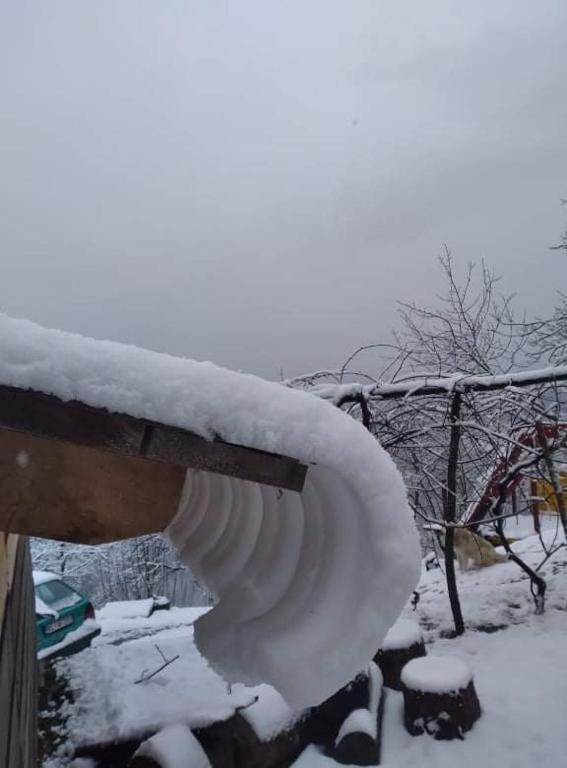 a bench covered in snow next to a fence at Dulović - KATUN POTOCI in Kolašin