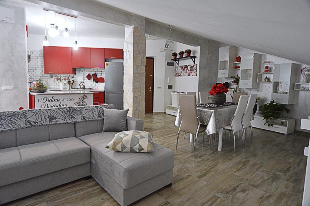 a living room and kitchen with a couch and a table at A Casa di Lalla in Bracciano
