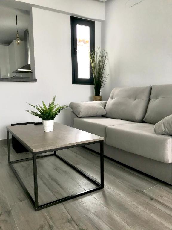 a living room with a couch and a coffee table at Apartamento Loft Lucena in Lucena
