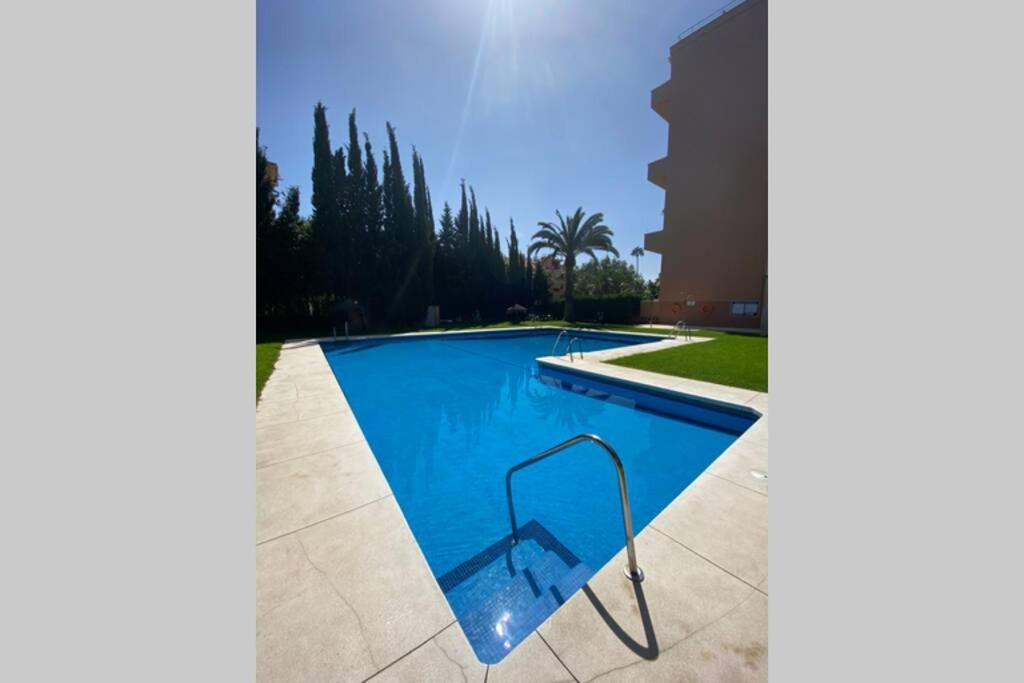 a swimming pool with a swing in the middle at Ocean view, Luxury & Relax Dunas de Artola in Marbella