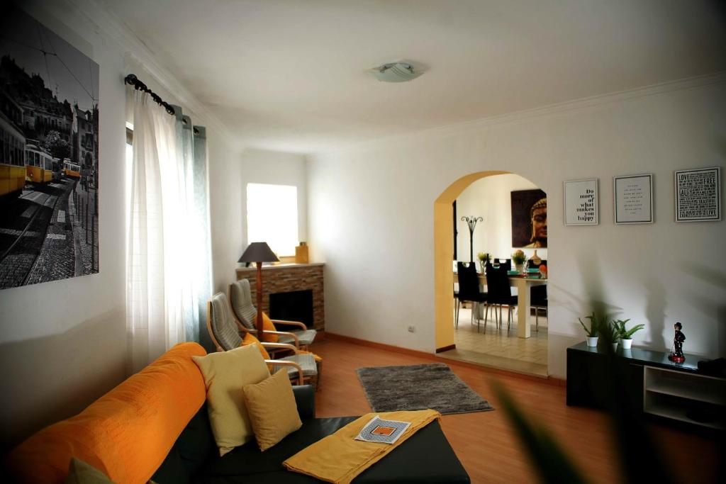 a living room with a couch and a dining room at Casa Ana in Nazaré