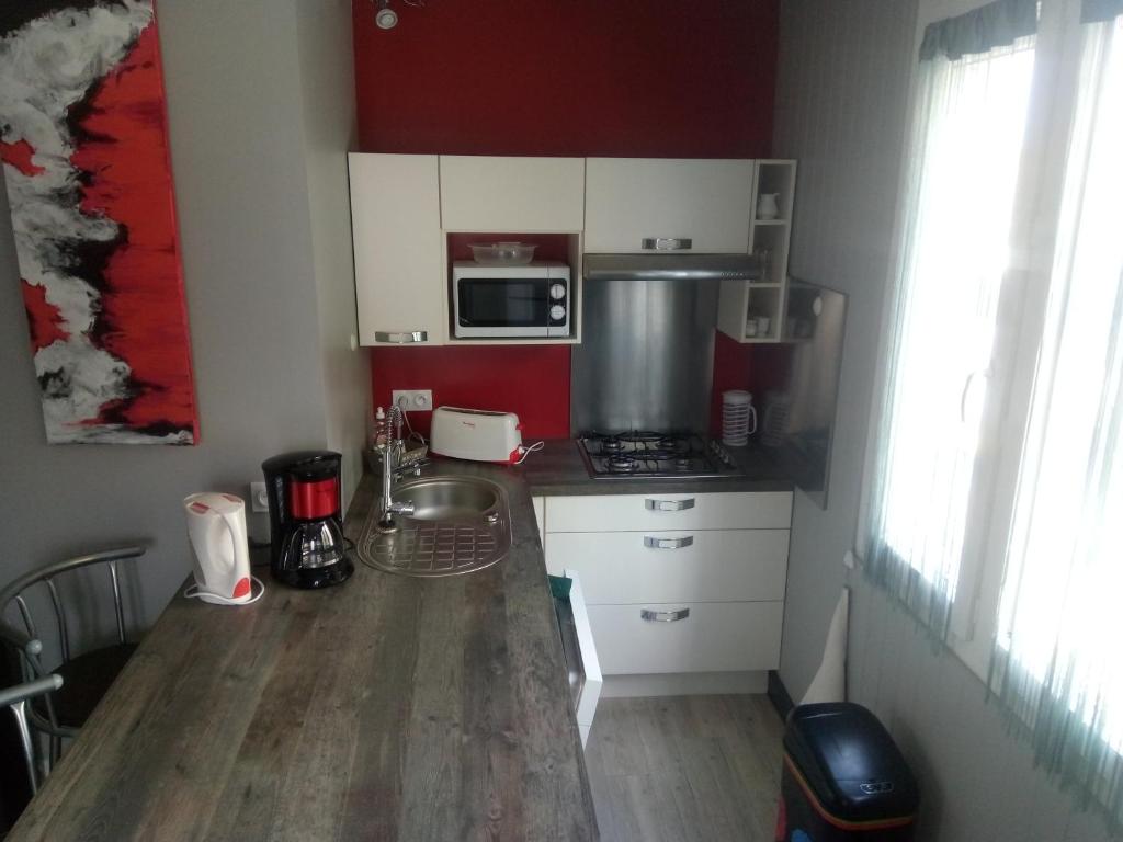 a small kitchen with a sink and a stove at GM in Bagnères-de-Bigorre