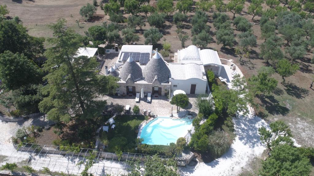 an aerial view of a house with a swimming pool at Trulli Anna in Cisternino