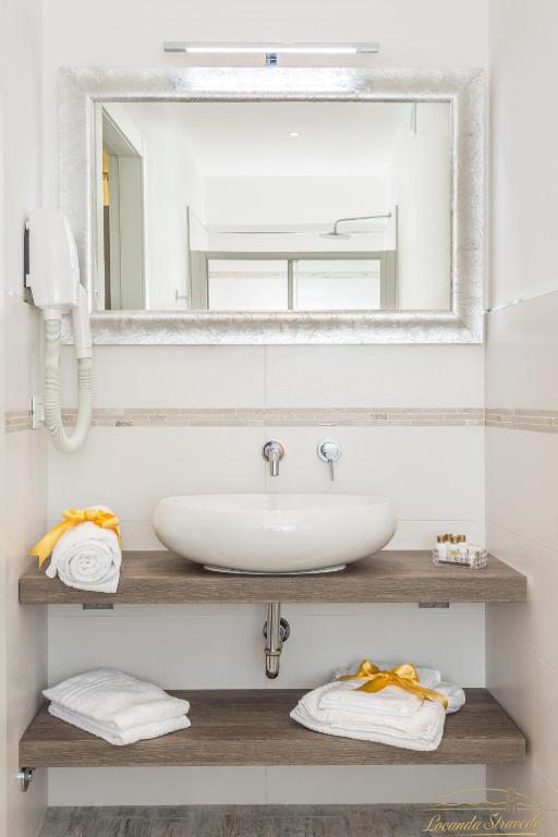 a bathroom with a sink and a mirror at Locanda Stravedo in Pellestrina
