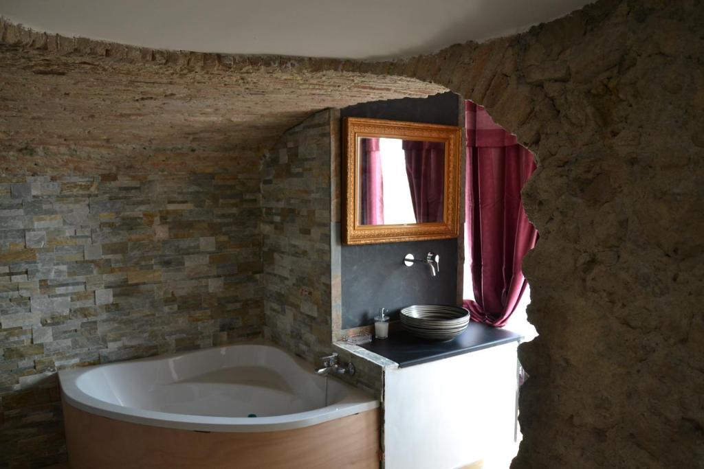 a bathroom with a bath tub and a sink at B&B Torre Porta Marina in Ventimiglia