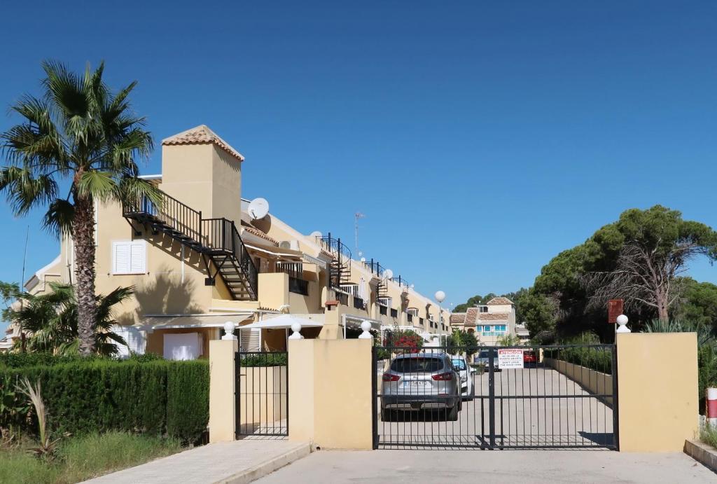 a car parked in front of a house with a gate at Emilia de la Playa in La Mata