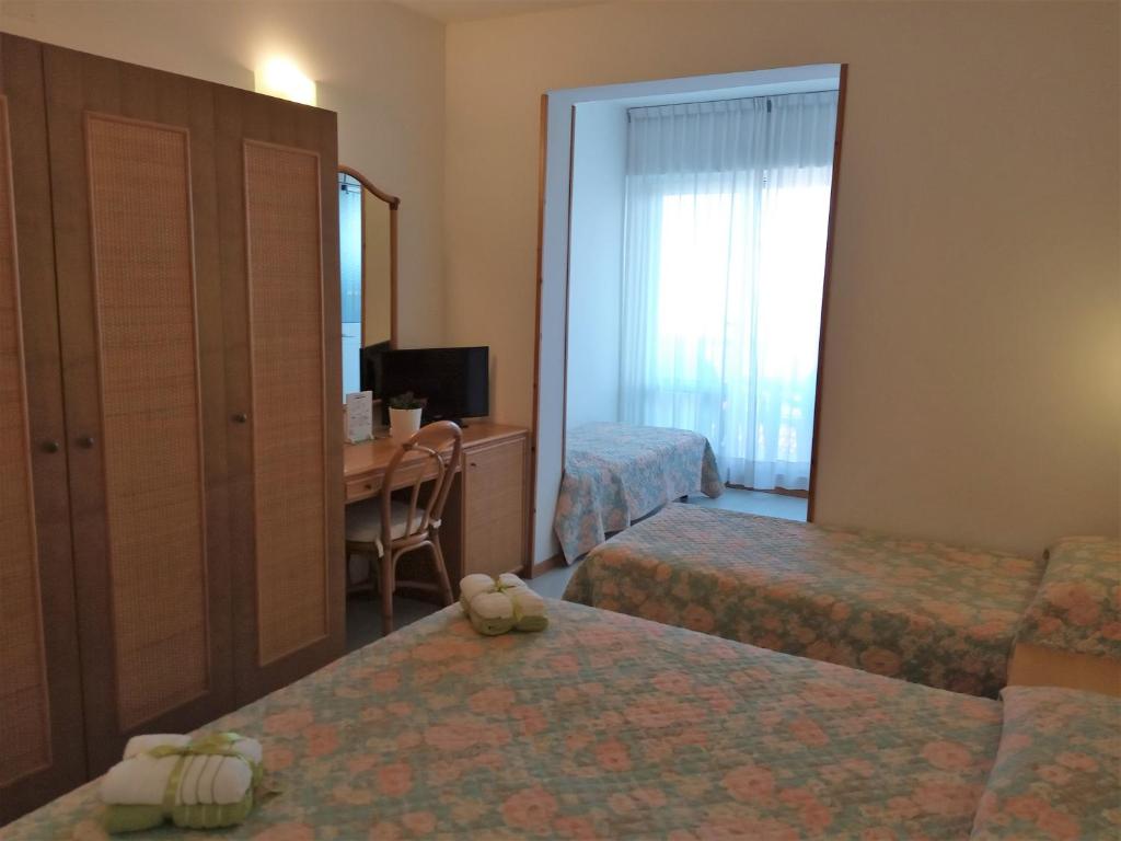 Postel nebo postele na pokoji v ubytování Hotel Capri