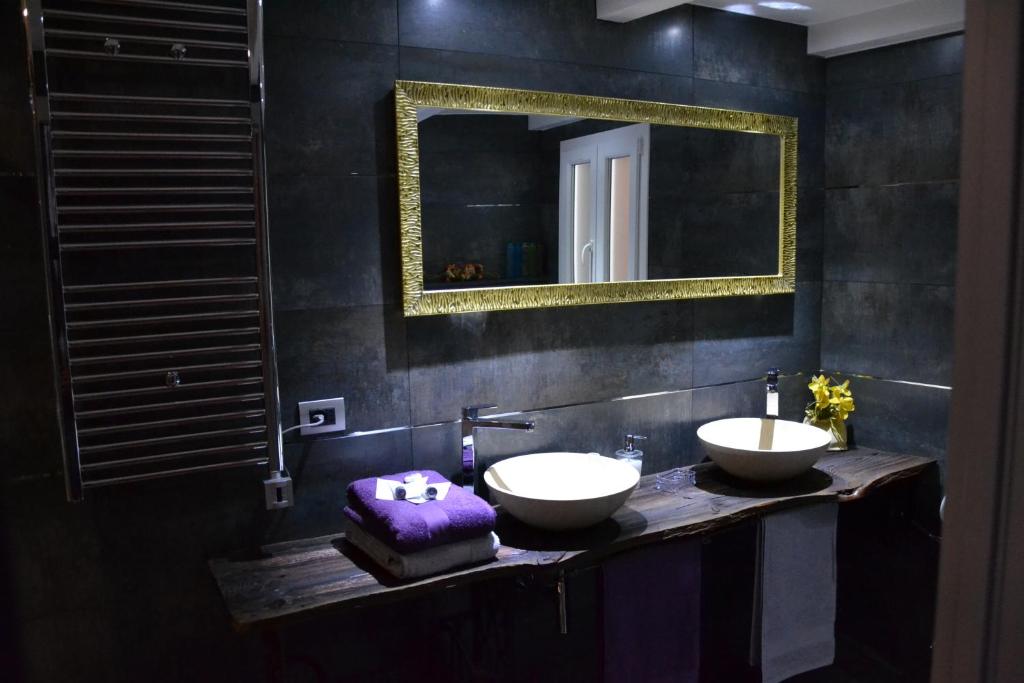 a bathroom with two sinks and a mirror at B&B Torre Porta Marina in Ventimiglia
