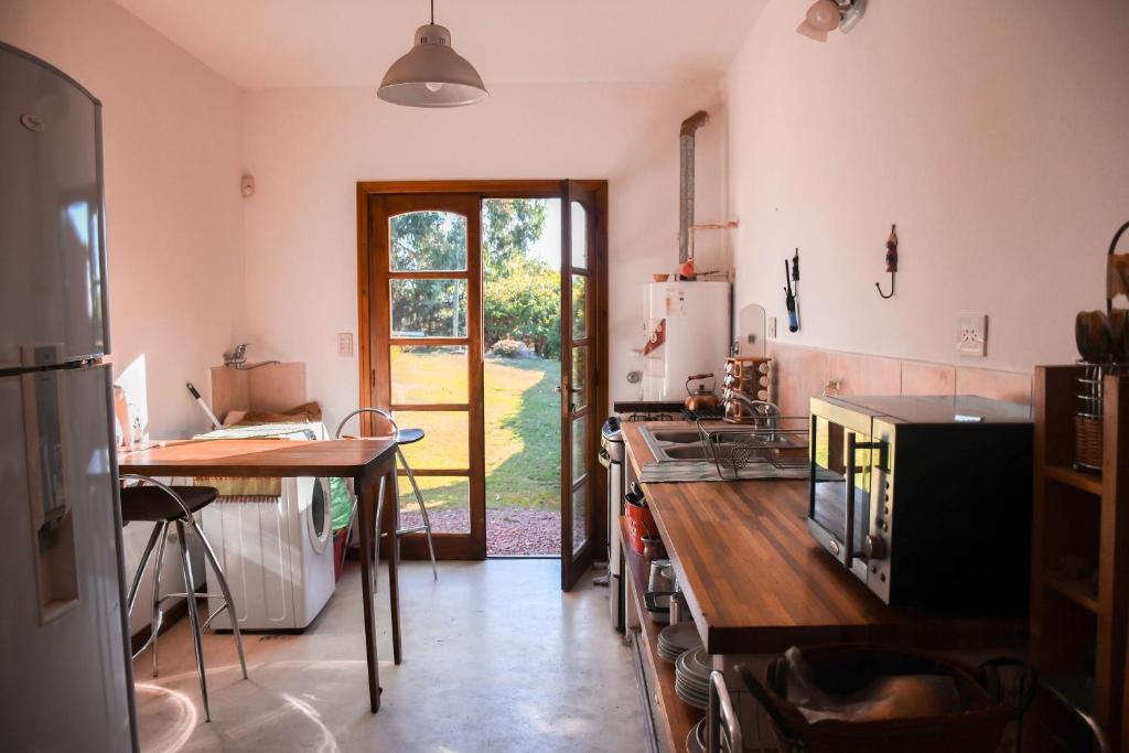 a kitchen with a sink and a table in it at Casa Bordó, B & B in Tandil