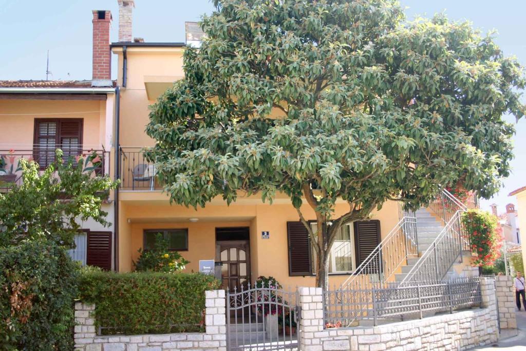 a tree in front of a house with a staircase at Apartment in Rovinj/Istrien 11533 in Rovinj