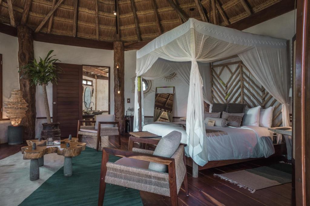 a bedroom with a bed with a canopy at Delek Tulum in Tulum