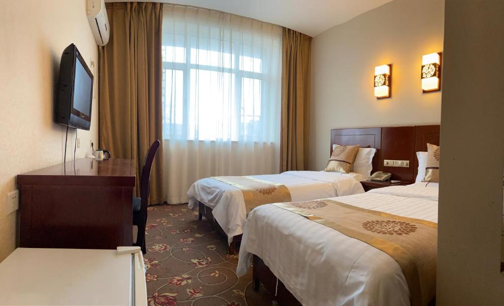 Postel nebo postele na pokoji v ubytování King Parkview Hotel