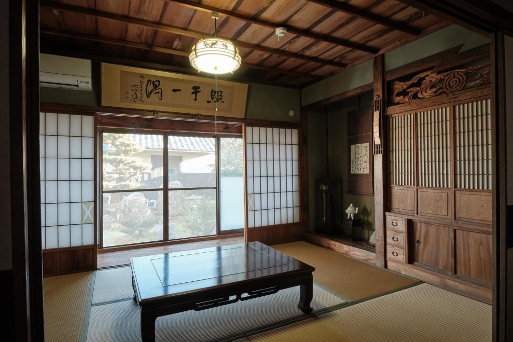 a room with a glass table and a window at Song Yin Pavilion / Vacation STAY 78854 in Shimosato