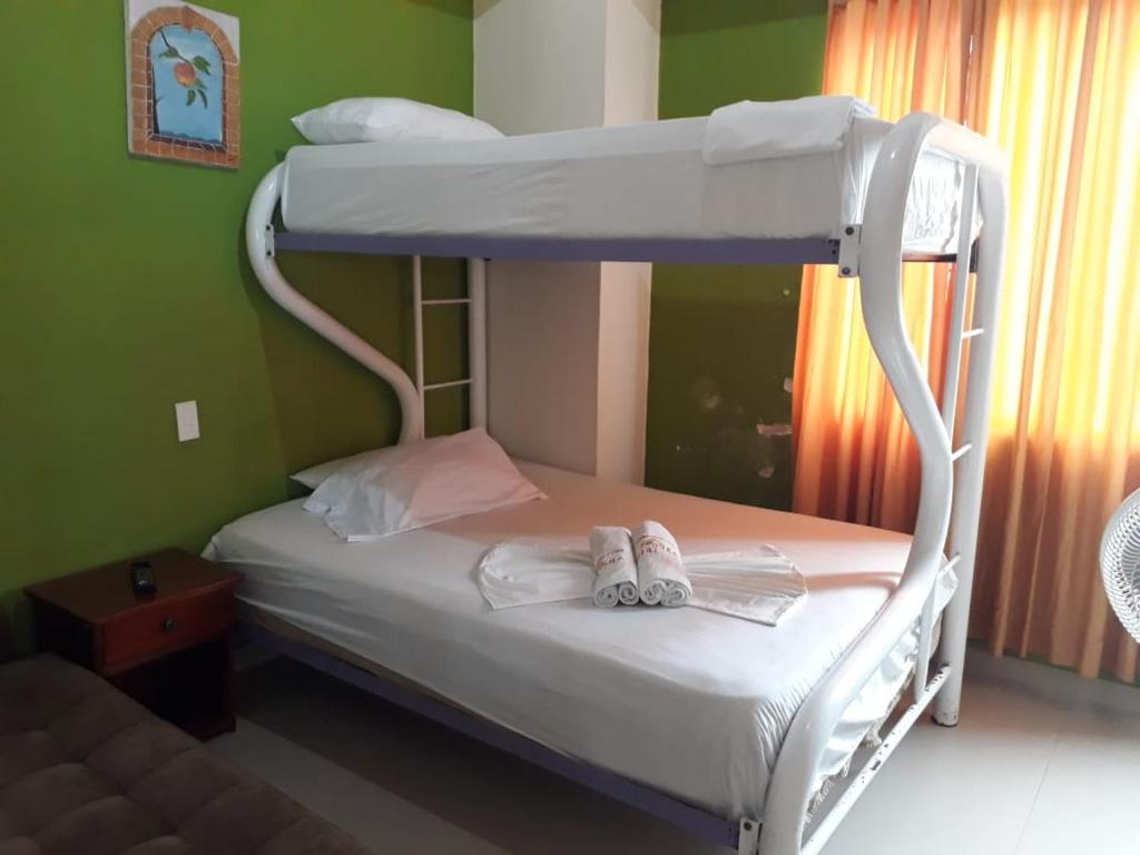 Postel nebo postele na pokoji v ubytování Hotel Arco Iris