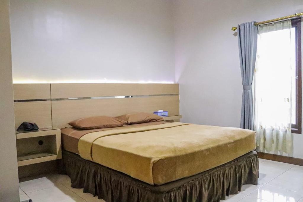 Postel nebo postele na pokoji v ubytování Hotel Pesona Merak