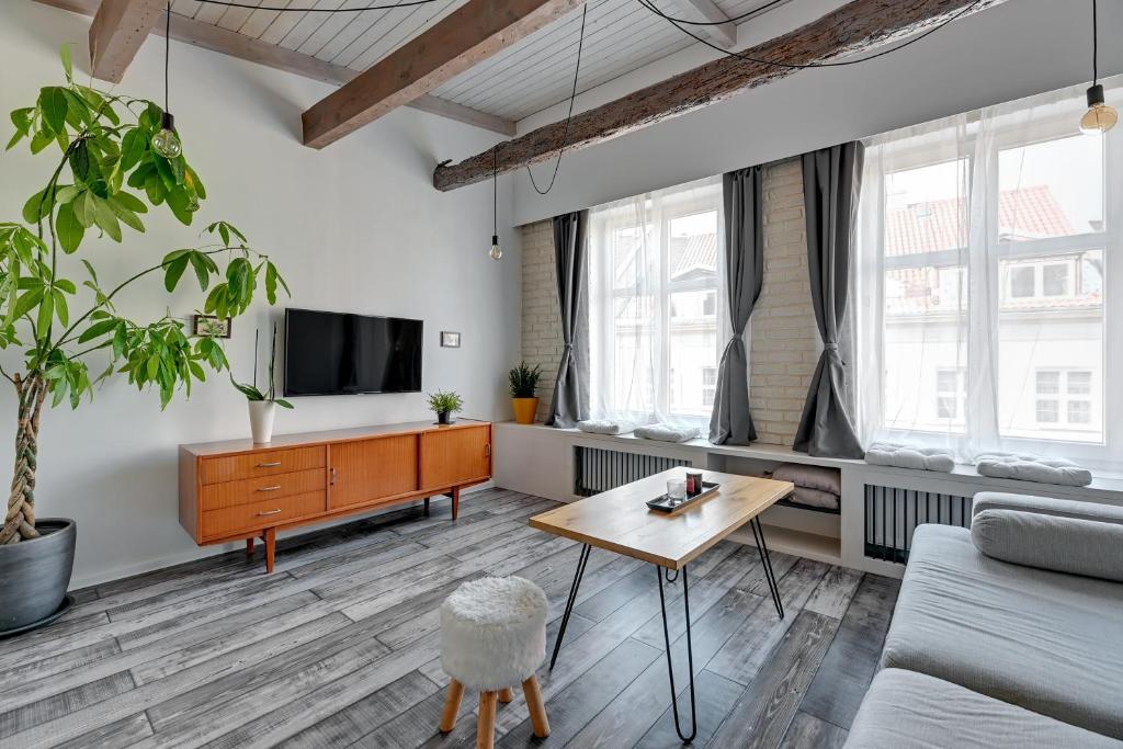 a living room with a couch and a table at Platinium Garncarska Old Town in Gdańsk