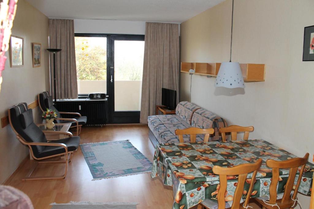 a living room with a couch and a table and chairs at Ferienwohnung F237 für 2-4 Personen an der Ostsee in Brasilien