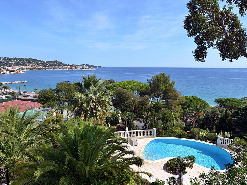 a swimming pool with a view of the ocean at Lou Trelus in Sainte-Maxime