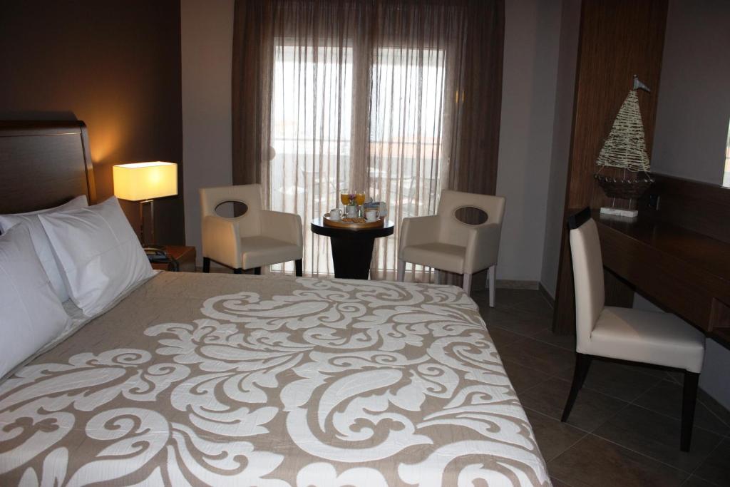 Postel nebo postele na pokoji v ubytování Hotel Cariatis