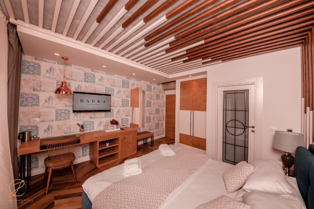 a bedroom with a bed and a desk in it at Barka B'n'B - Elegant Seaview Rooms in Herceg-Novi