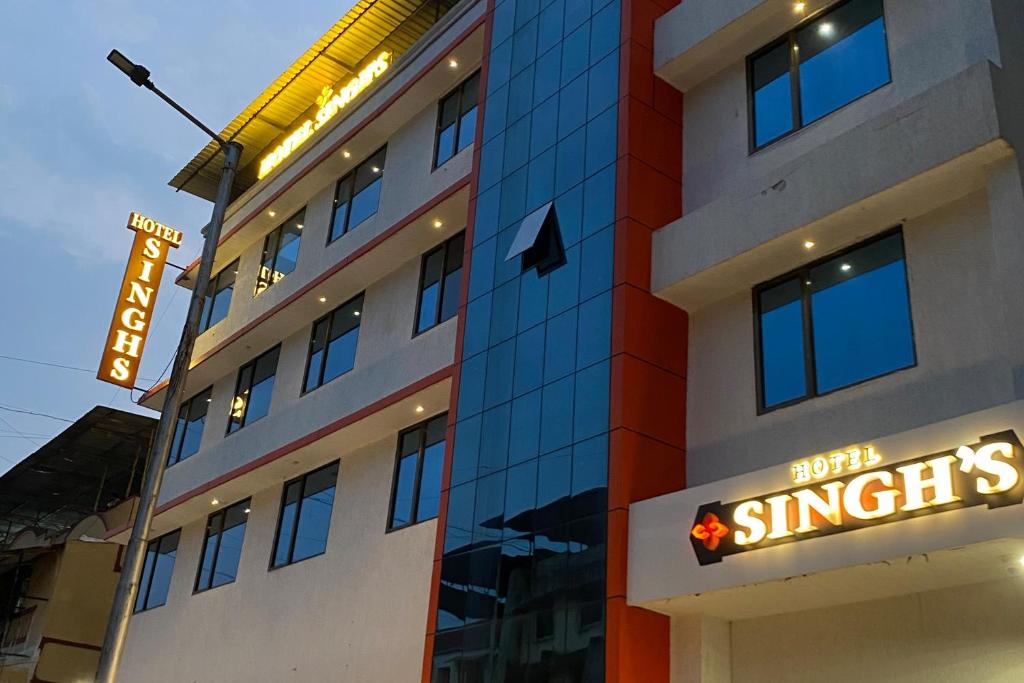 a building with a sign on the side of it at Hotel Singh`s By WB Inn, Vashi, Navi Mumbai in Navi Mumbai