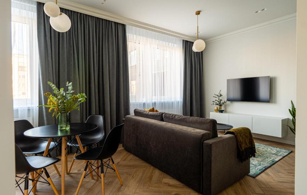 a living room with a couch and a table at Cozy Apartment In Kaunas Center in Kaunas