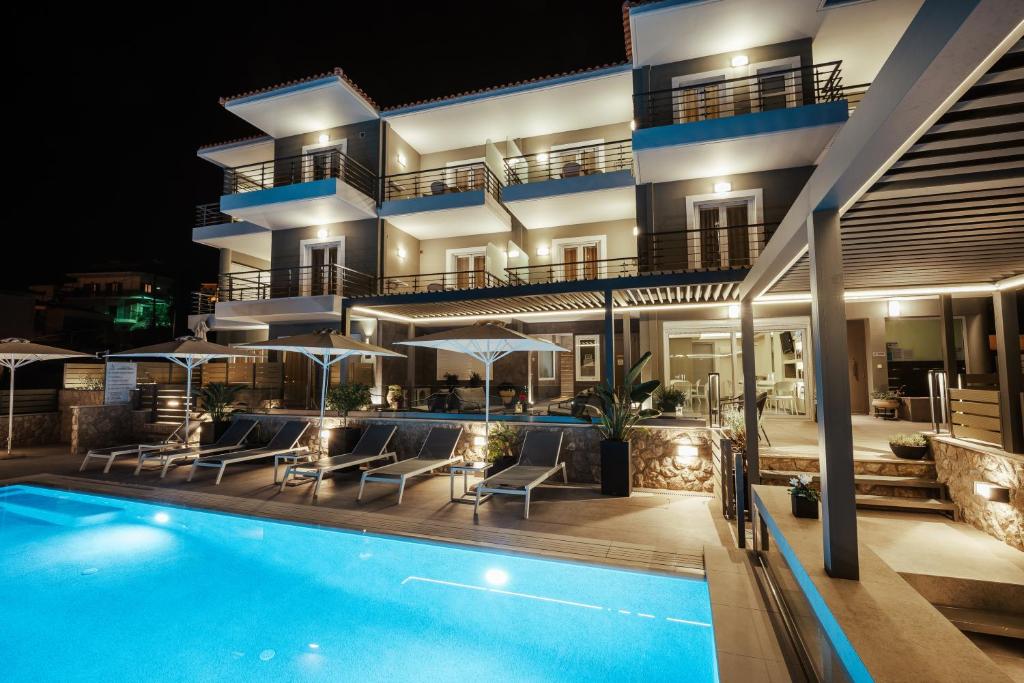 a villa with a swimming pool at night at Andrew's Luxury Residence in Nafplio