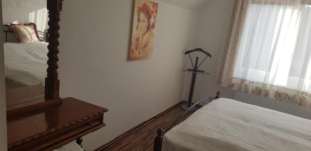 a bedroom with two beds and a mirror and a dresser at Mimi Apartment in Nyíregyháza