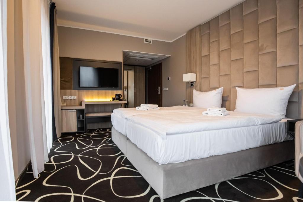 Postel nebo postele na pokoji v ubytování Trofana Wellness & SPA