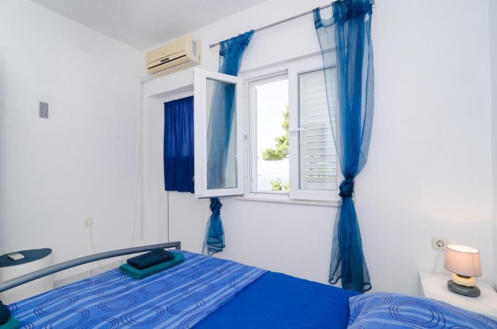 Postel nebo postele na pokoji v ubytování Apartments Ammos