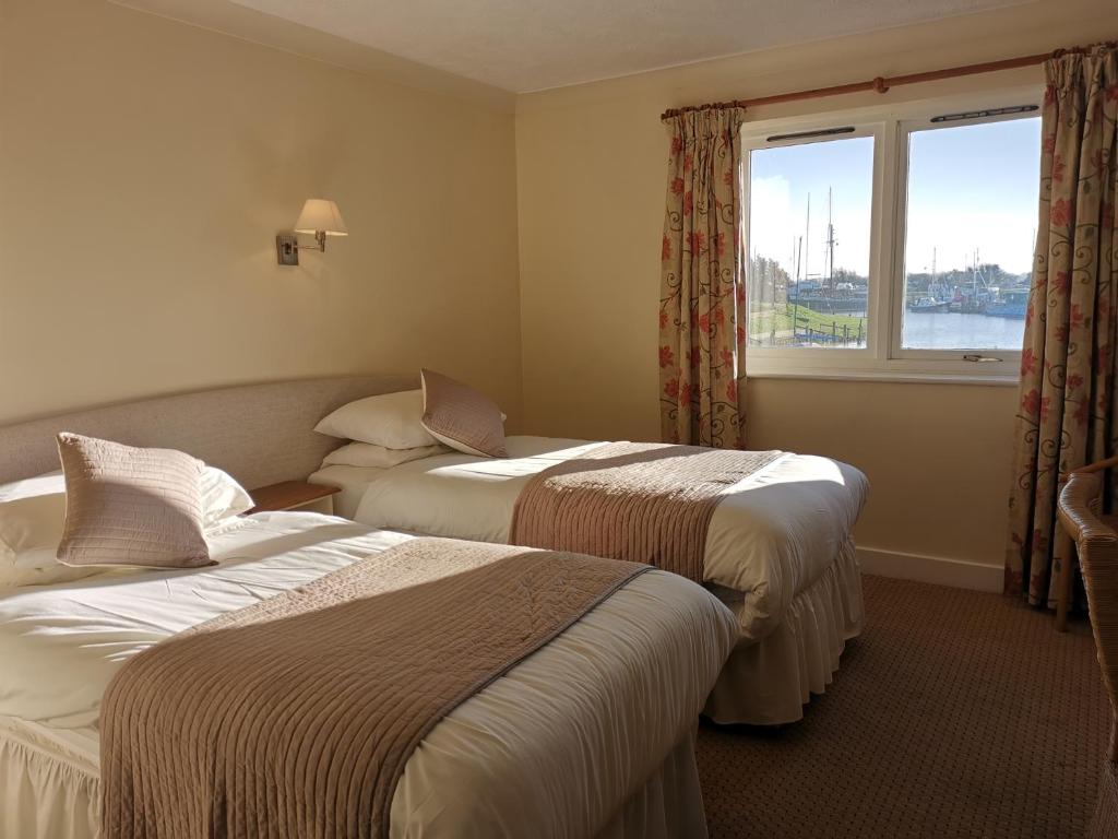 A bed or beds in a room at The River Haven Hotel
