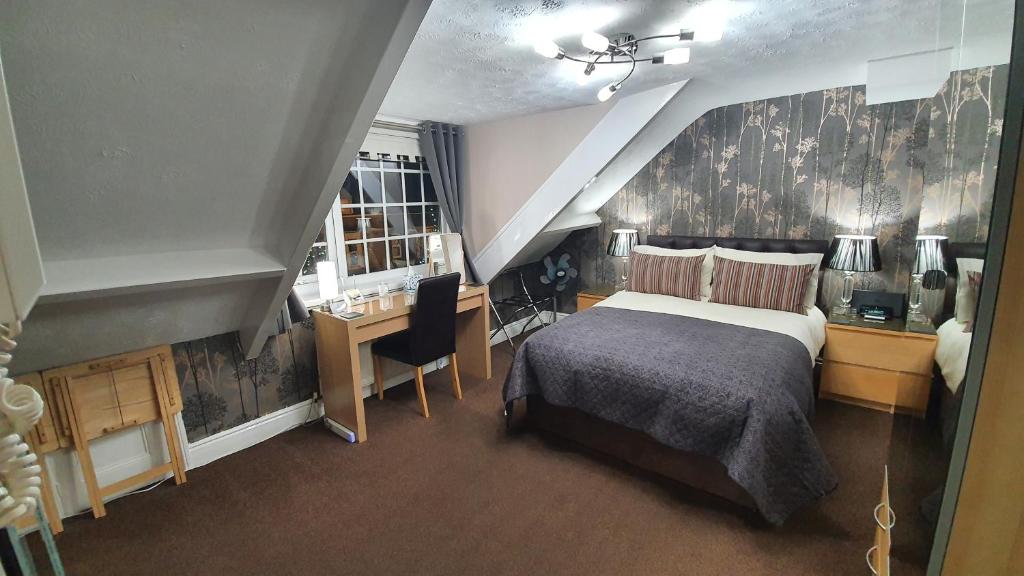 a bedroom with a bed and a chair at Beechwood Guest House in South Shields
