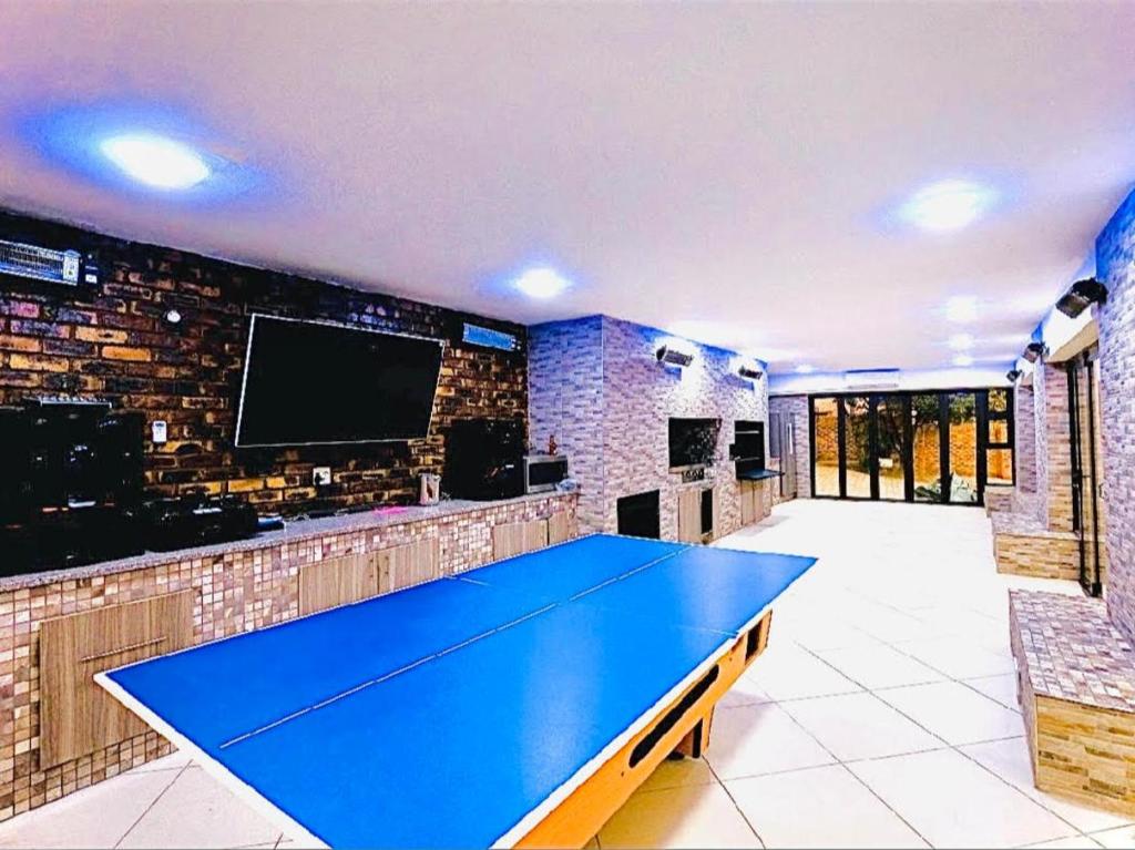 a blue ping pong table in a room with a tv at C&C HOTEL VIBES Randpark Ridge JHB 14 Units Available in Boskruin