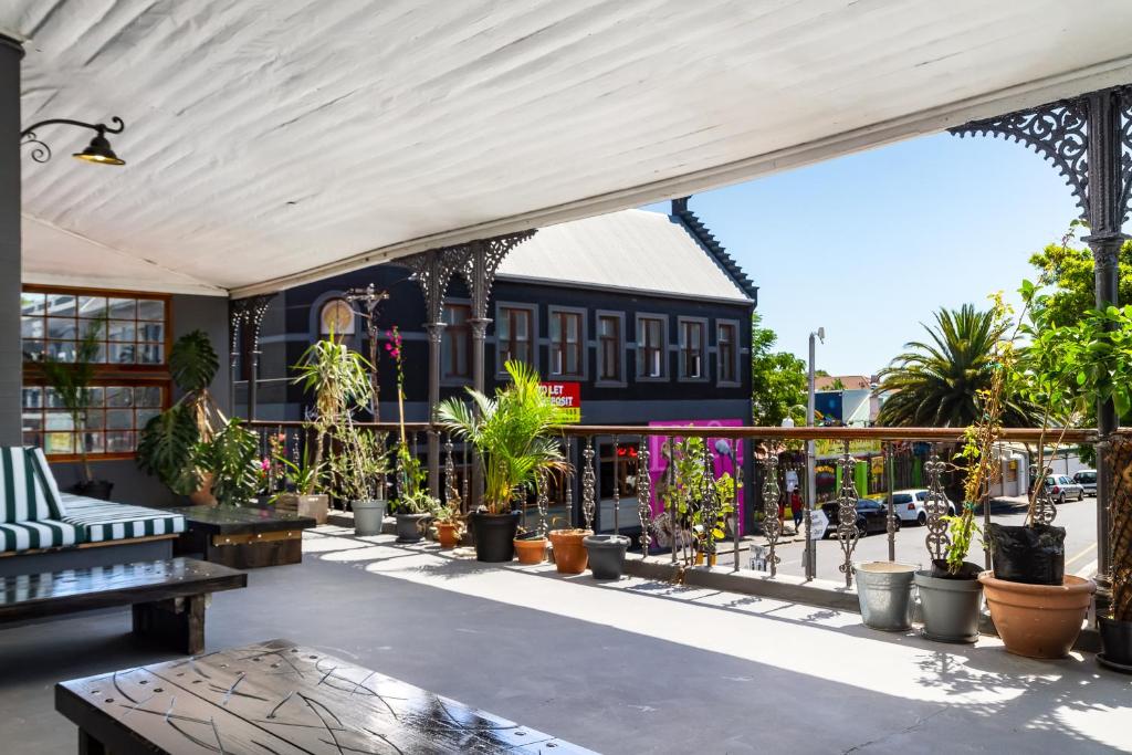 an outdoor patio with potted plants and a building at Obz Hotel in Cape Town