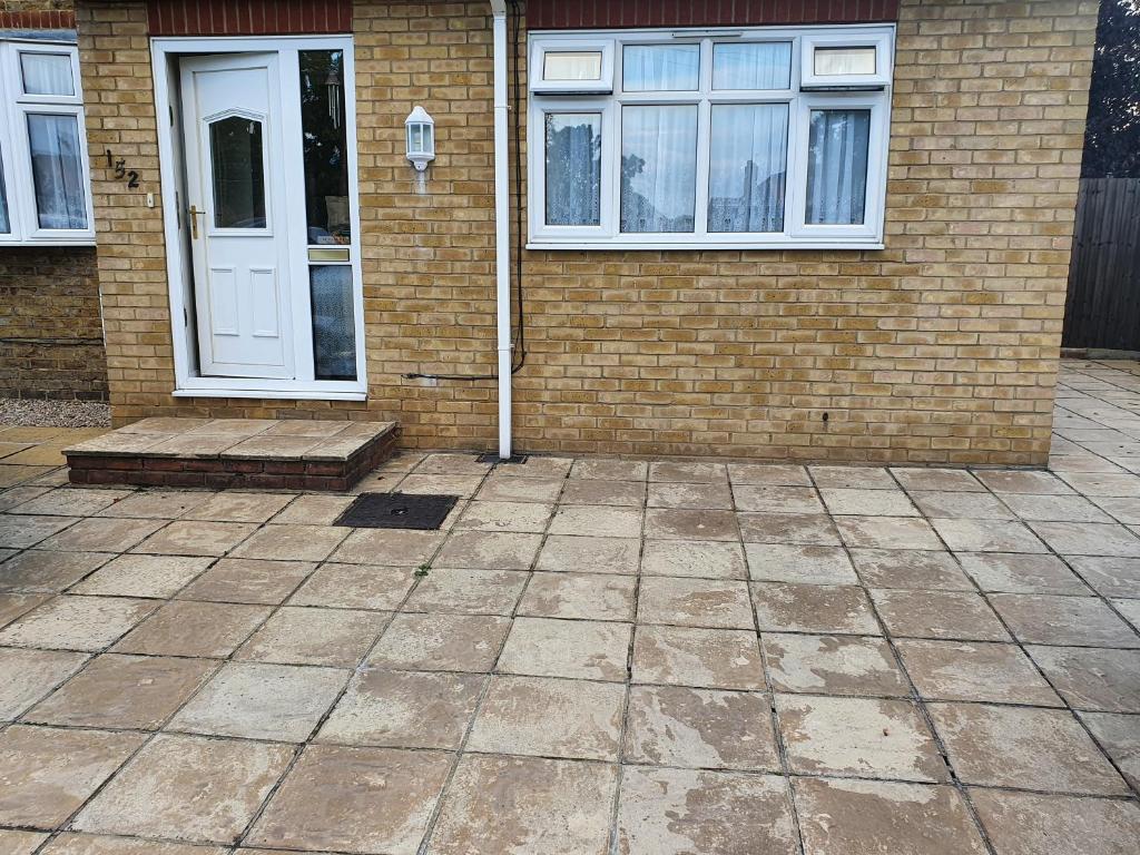 a brick house with a white door and windows at Eltham-Lee in Eltham