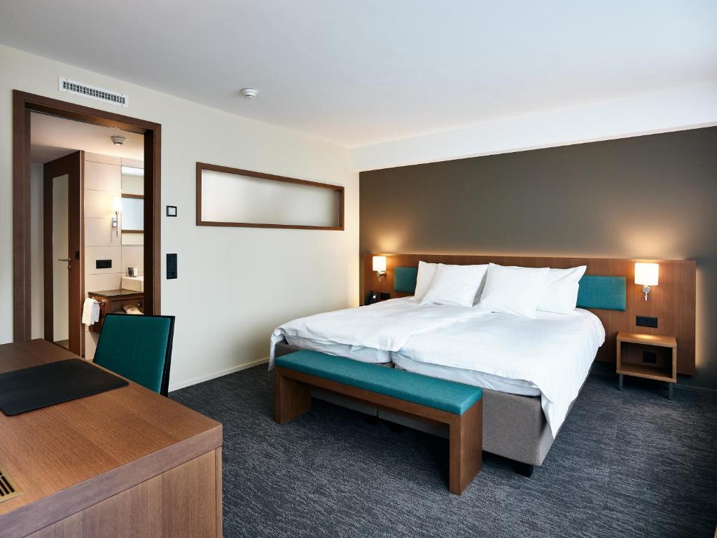 Postel nebo postele na pokoji v ubytování Belvédère Strandhotel
