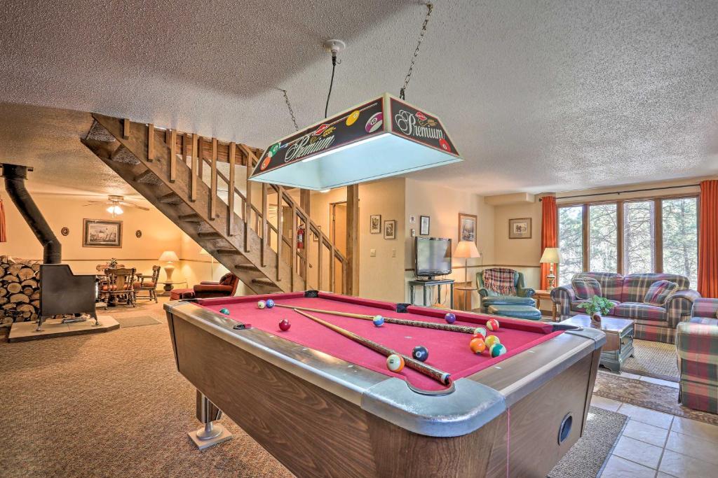 a living room with a pool table in a room at Cozy Black Hills Nature Retreat with Private Deck! in Rapid City