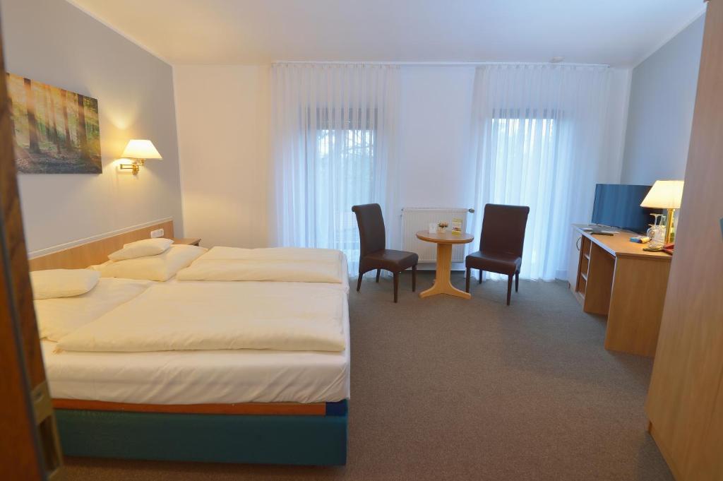 Postel nebo postele na pokoji v ubytování Hotel Bertram