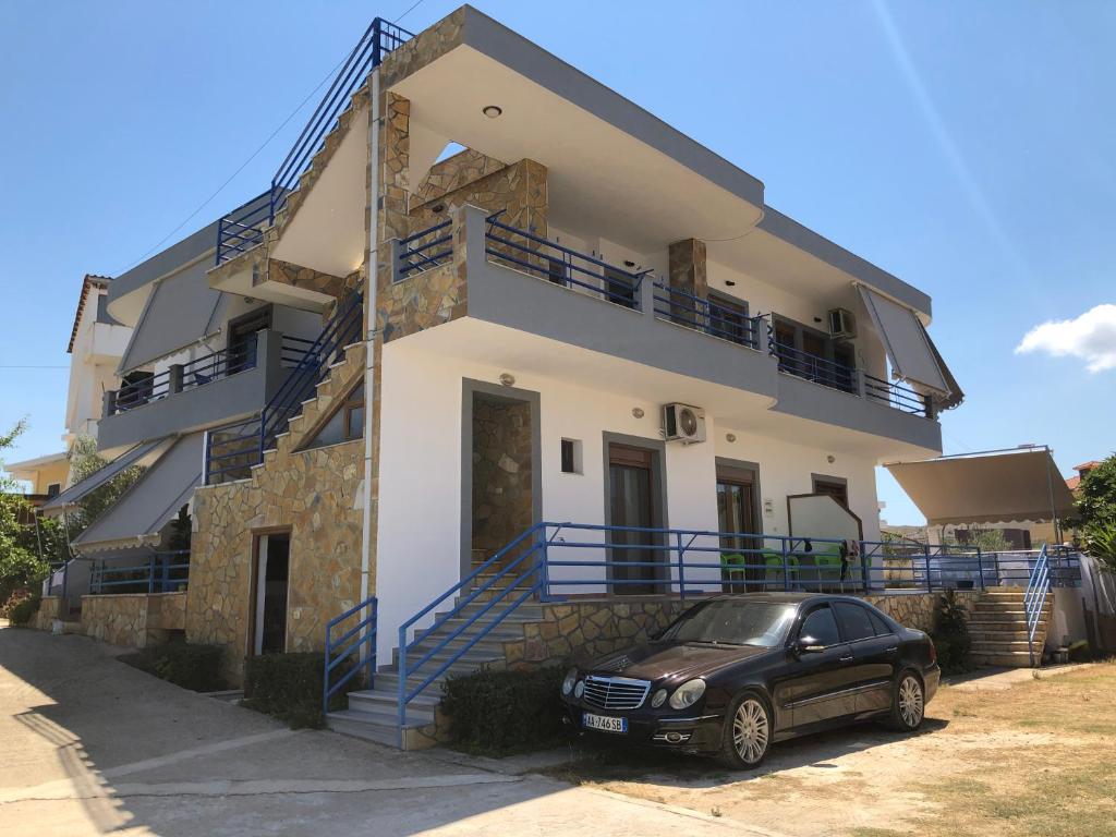 um carro preto estacionado em frente a uma casa em Guesthouse Jasmine em Ksamil