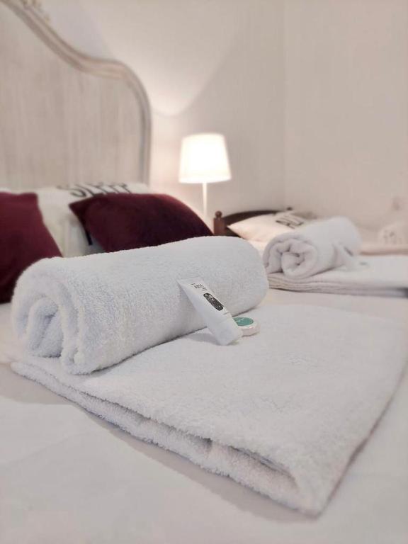 two white towels on a bed in a room at Pod Różą Economy in Łeba